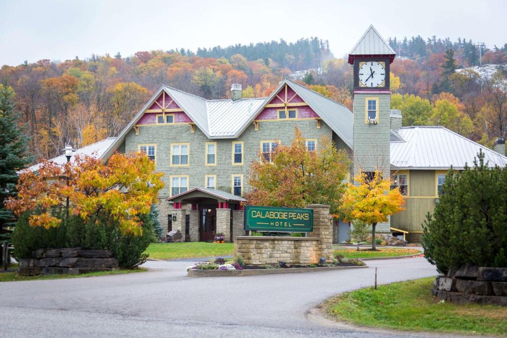 a large building with a clock tower in front of it at Calabogie Peaks Hotel, Ascend Hotel Member in Calabogie
