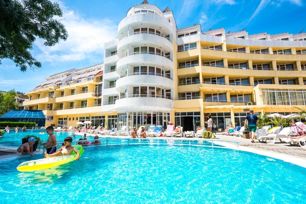 a swimming pool in front of a hotel at Sun Palace Hotel in Sunny Beach