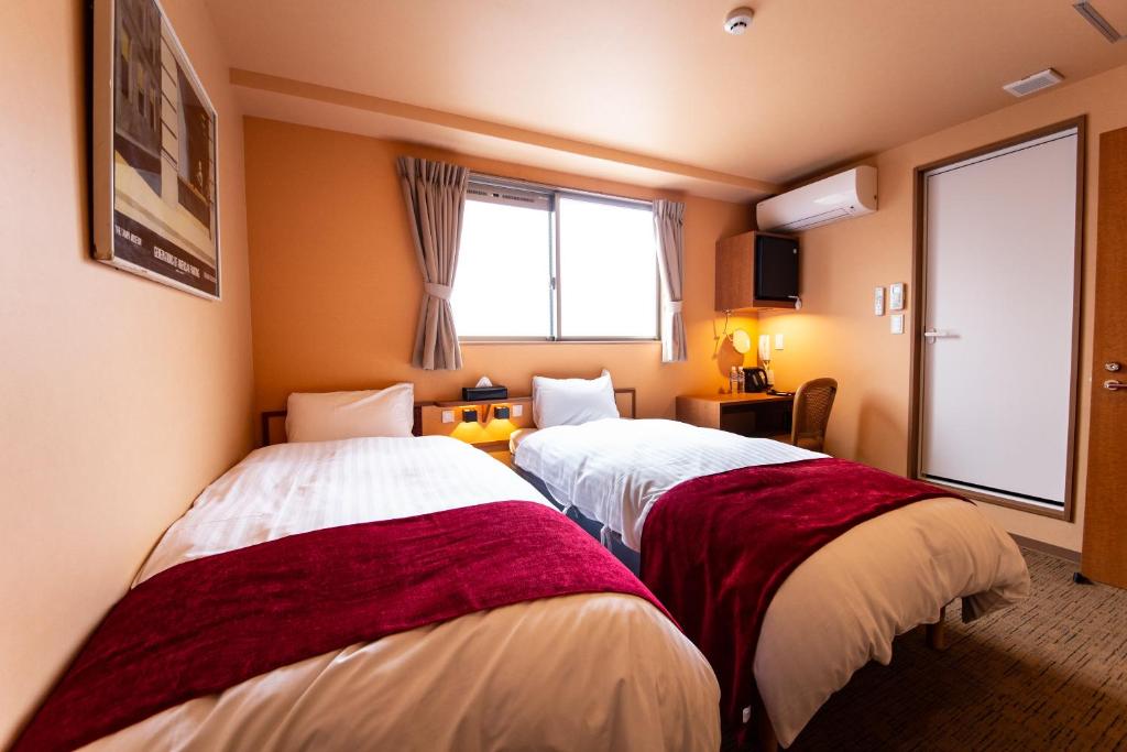 Postel nebo postele na pokoji v ubytování THE L.A. MART HOTEL KYOTO