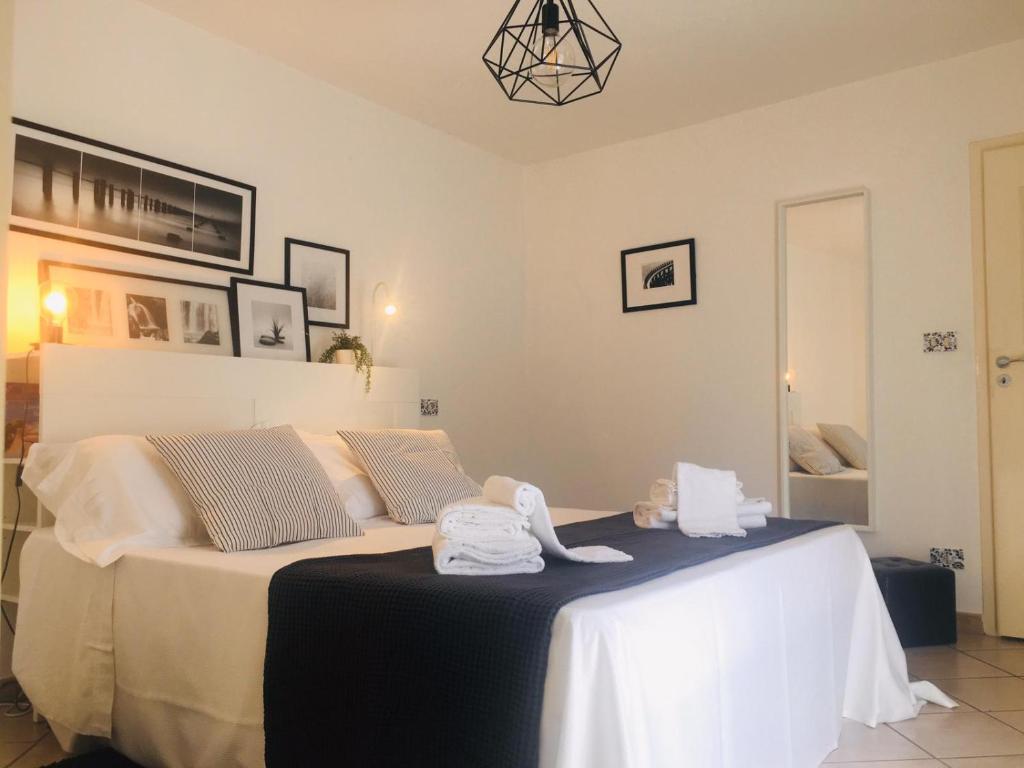a bedroom with a large bed with towels on it at Pancrazio in Taormina
