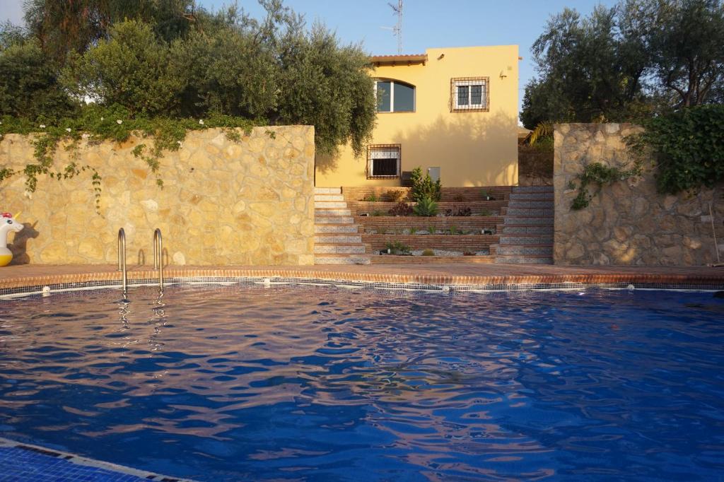 a house and a swimming pool in front of a house at Cortijo del Aguila in Mojácar