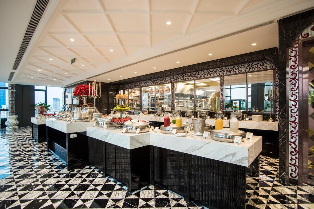 a restaurant with a buffet line in a building at The Reverie Saigon in Ho Chi Minh City