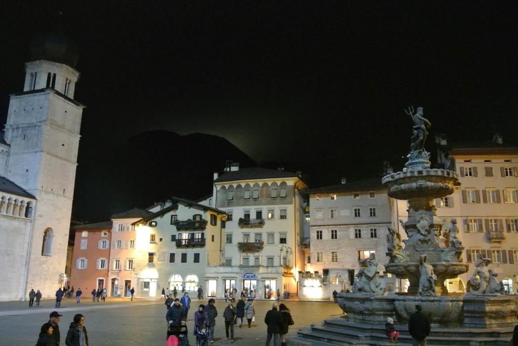 a large building with a clock on the top of it at Scrigno del Duomo in Trento