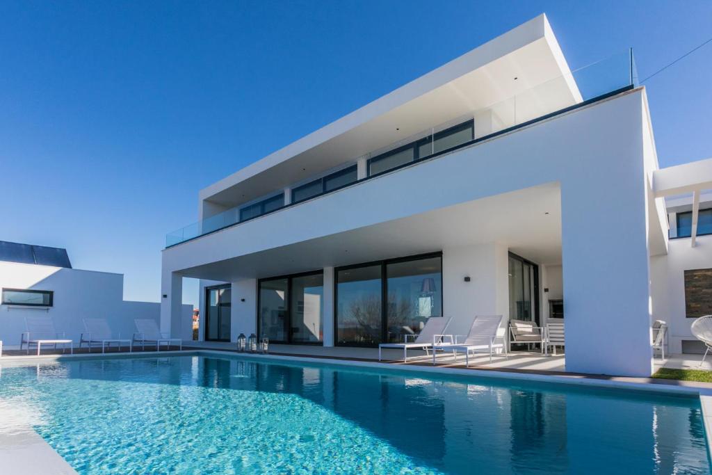 a villa with a swimming pool and a house at The Villa / Ericeirahills in Ericeira