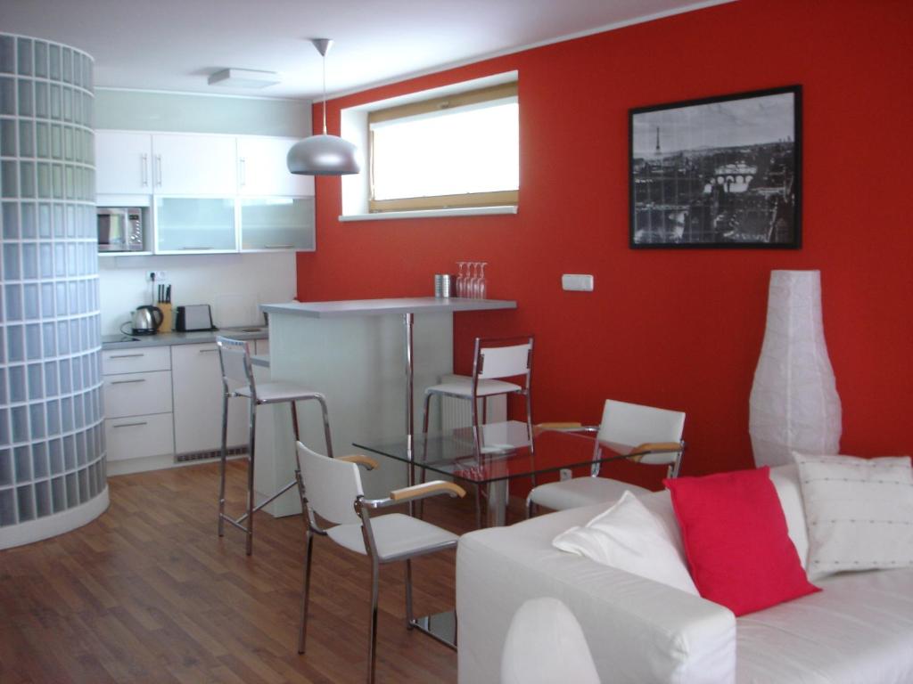 a living room with a white couch and a red wall at Apartmán Anežka in Luhačovice