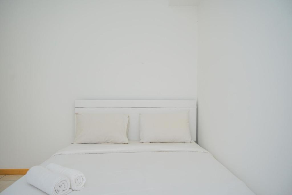 a white bed with white sheets and pillows at New Furnished 2BR Apartment at Serpong M-Town Residence By Travelio in Tangerang