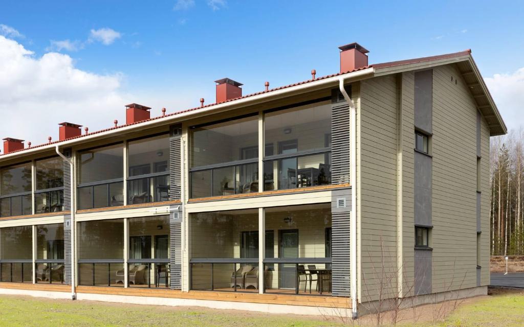 an external view of a building with large windows at Holiday Club Vierumäki Superior Apartments in Vierumäki