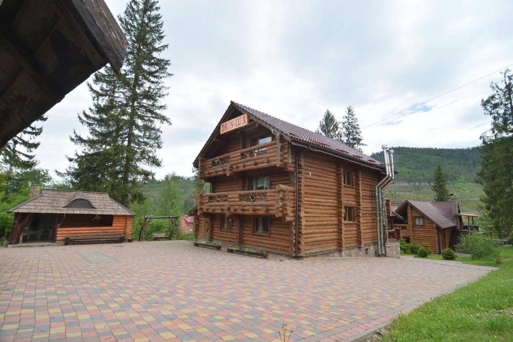 a log cabin with a patio in front of it at Drin-lux in Slavske