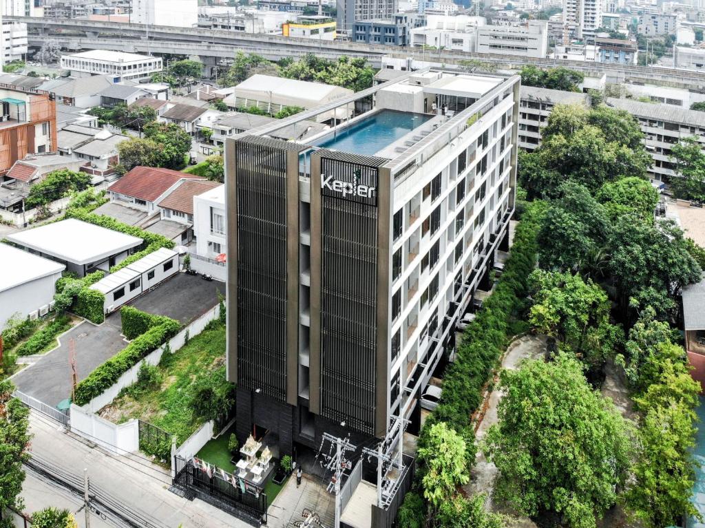an aerial view of a building with a swimming pool at Kepler Residence Bangkok in Bangkok
