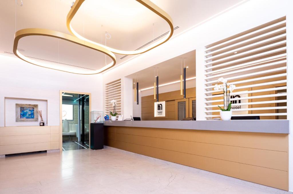 a lobby with a reception desk in a building at Best Western Hotel Nazionale in Sanremo