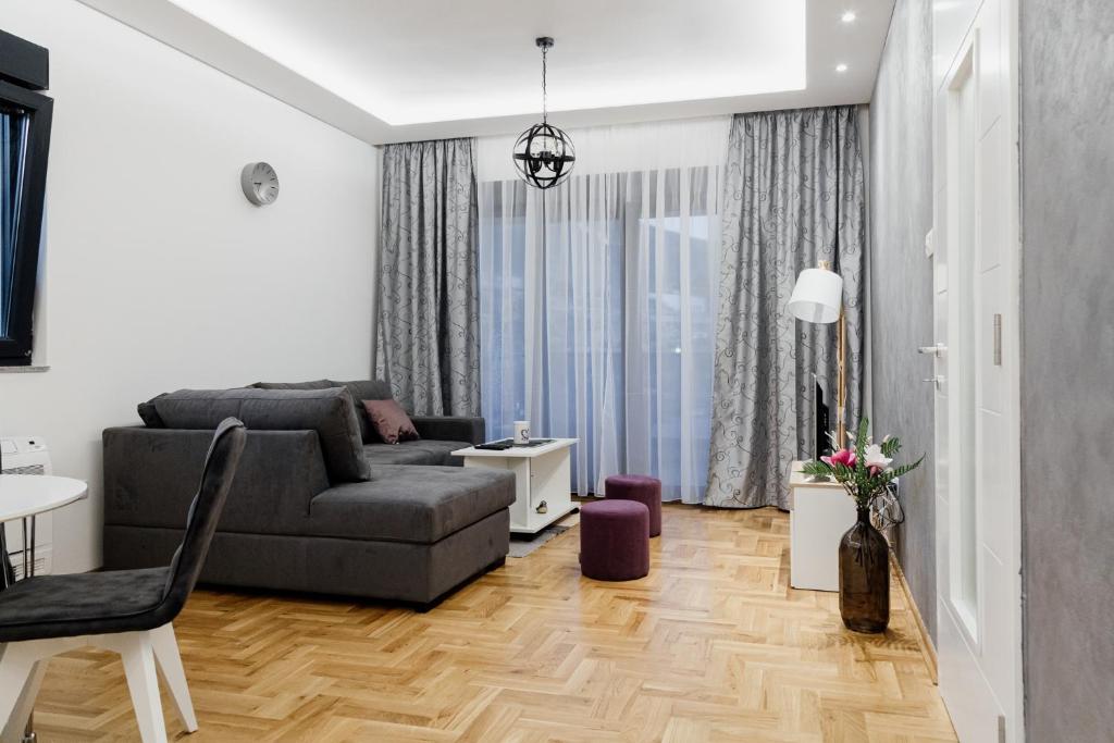 ein Wohnzimmer mit einem Sofa und einem Tisch in der Unterkunft Apartmans Centar in Trebinje