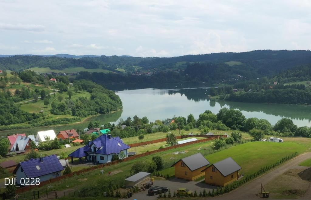 an aerial view of a small village next to a lake at Chaty Jak Dawniej in Wołkowyja