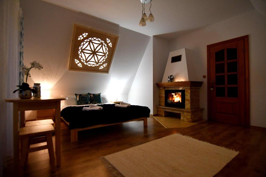 a bedroom with a bed and a fire place at Zakątek u Pary in Biały Dunajec
