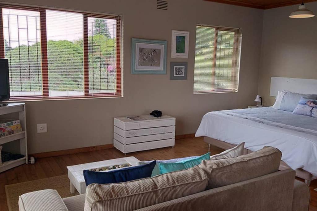 a living room with a bed and a couch at Whale of a Time - Sedgefield in Sedgefield