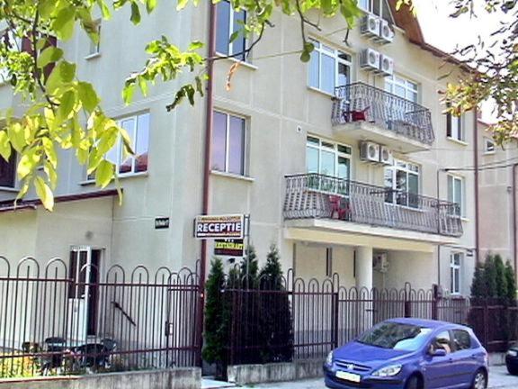 a blue car parked in front of a building at Moldotour in Iaşi