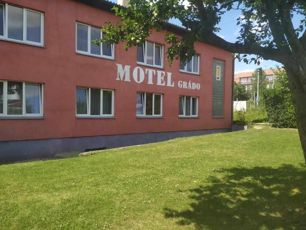 a building with a lawn in front of it at Motel Grádo in Prague