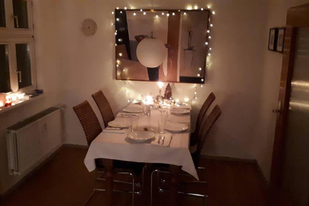 a dining room table with chairs and lights on it at Gemütliche Altstadtwohnung in Dinkelsbühl in Dinkelsbühl