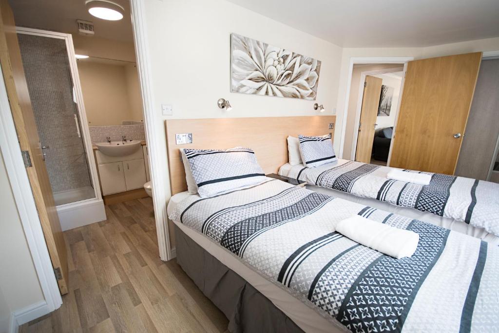 a hotel room with a bed and a desk at Lochend Serviced Apartments in Edinburgh
