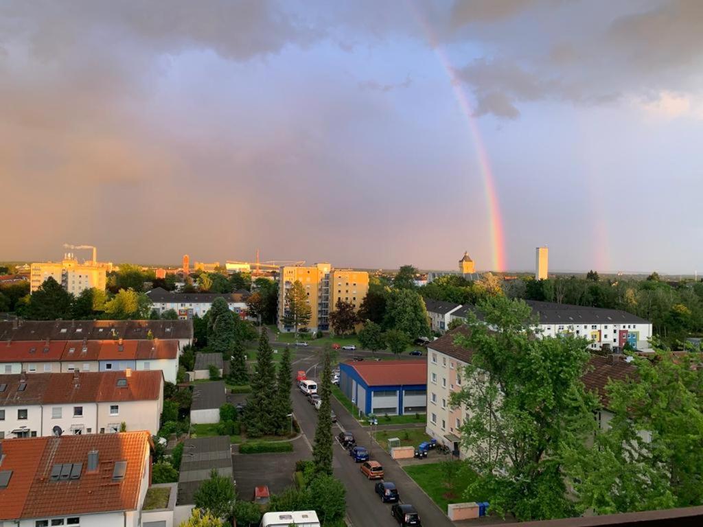 a rainbow in the sky over a city with buildings at Penthouse "Marc Aurel" - GreatView, WiFi & Netflix in Schweinfurt