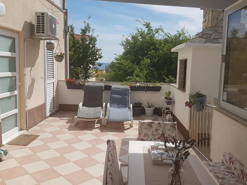 a patio with two chairs and a table at Apartment Mirjana in Makarska