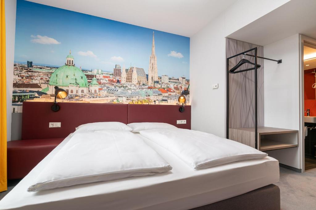 a bedroom with a large view of a city at Campanile Vienna South in Vienna