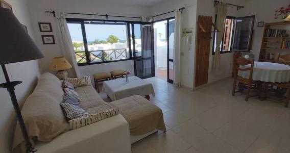 a living room with a couch and a table at Apt Casa Mamen spacious with sea views in Puerto del Carmen