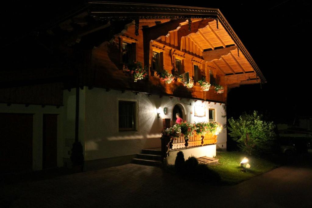 a building with flower boxes on the side of it at night at Landhaus Johanna in Dorfgastein