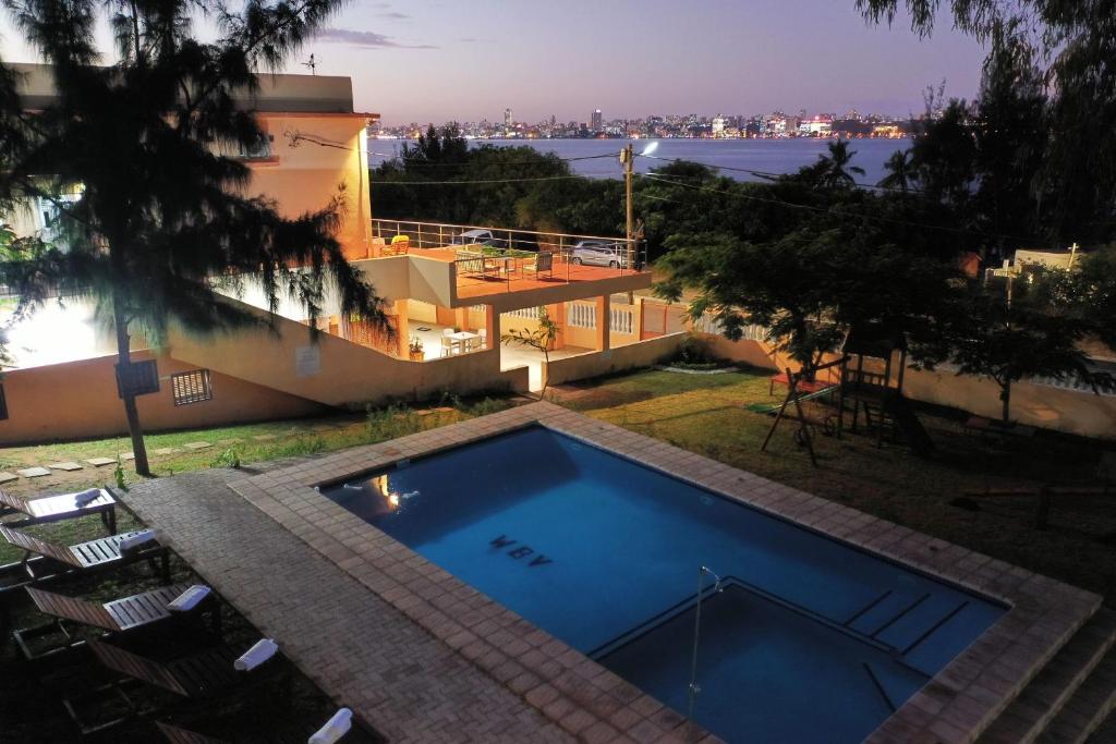 a swimming pool in the backyard of a house at Wonna Bay Vila Lodge-Catembe in Maputo