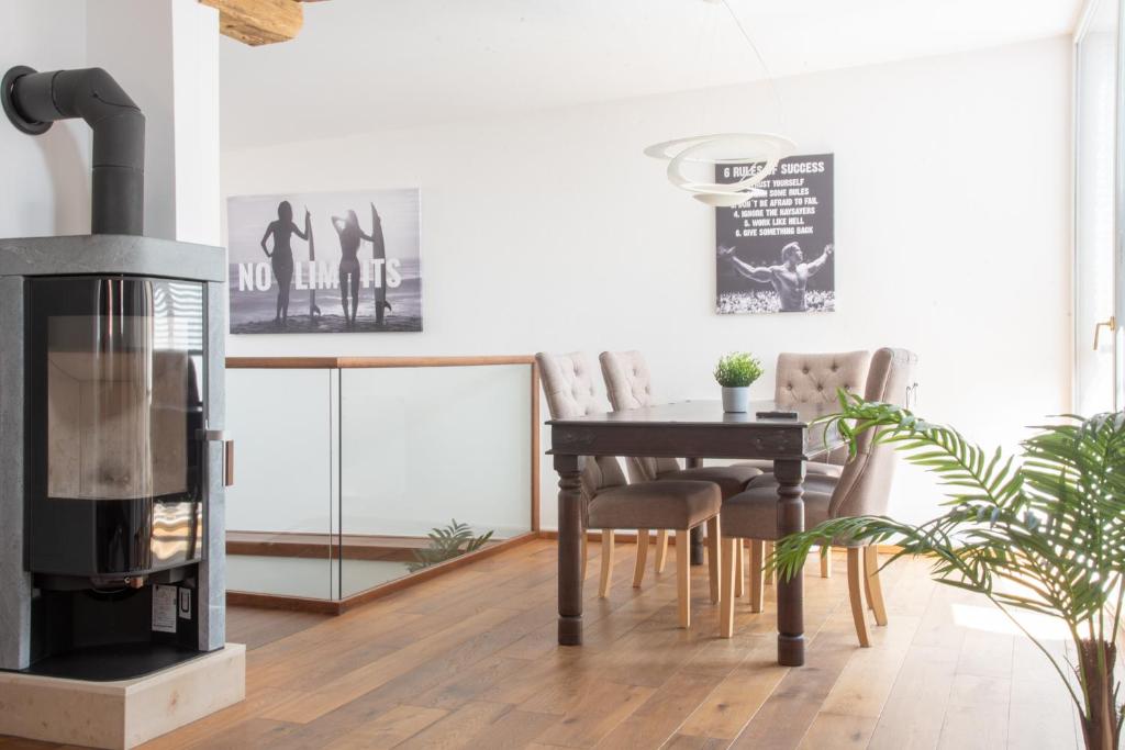 a living room with a wood stove and a table at DAREBELL – Designerapartments Sporgasse in Graz