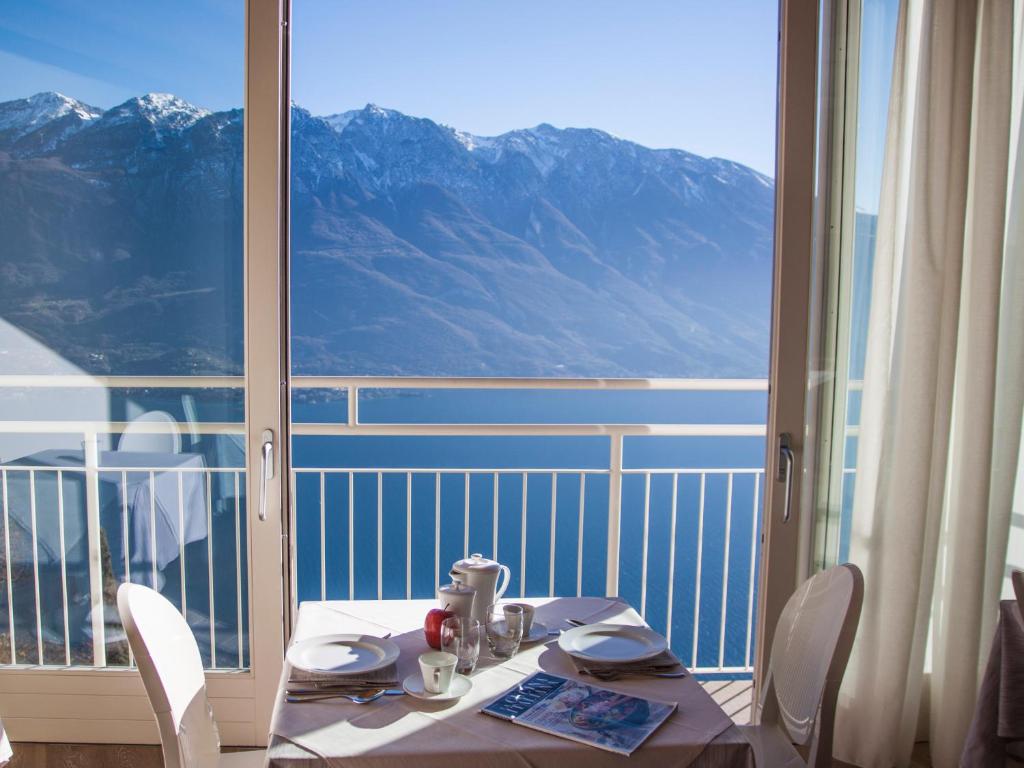 una mesa y sillas con vistas a la montaña en Locanda Al Castelletto en Tremosine Sul Garda