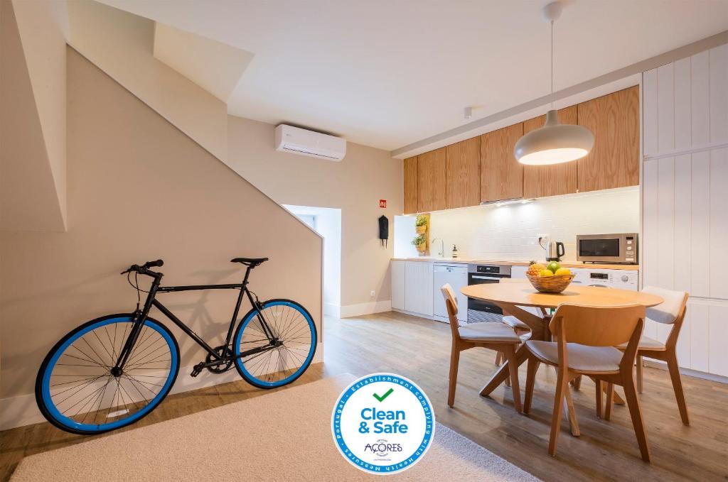 a bike parked next to a table in a kitchen at Matriz Lofts in Ponta Delgada