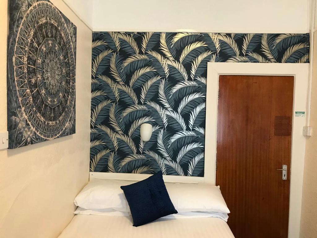 a bedroom with a black and white wall at The Feathers Hotel in Blackpool