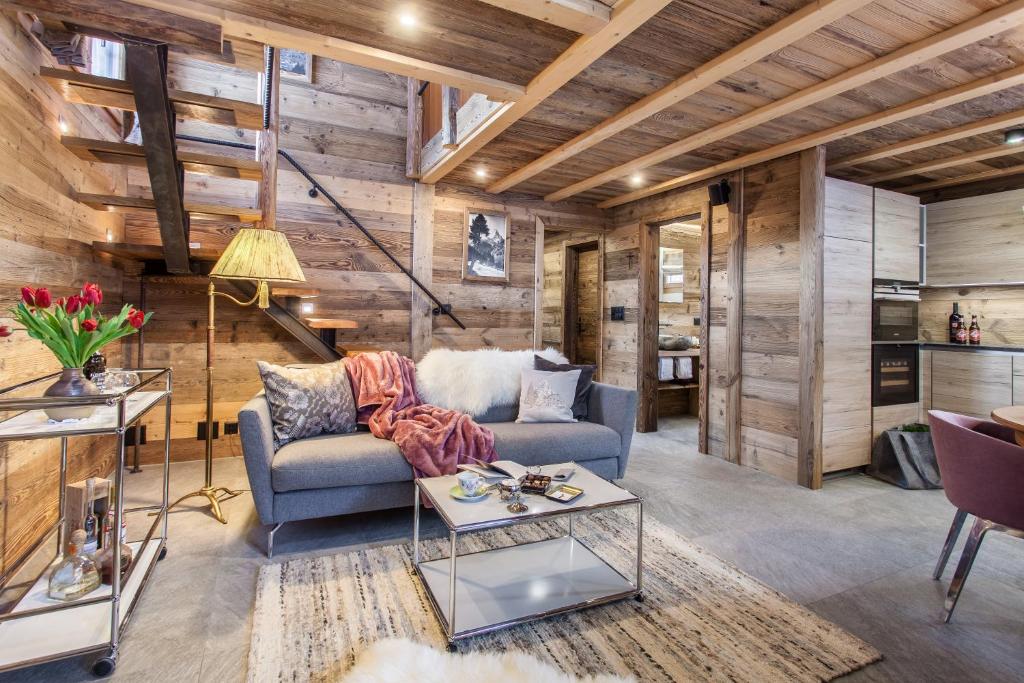 a living room with a couch and a table at Mountain Chalet 4 You in Zermatt