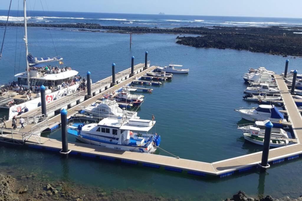 un grupo de barcos atracados en un puerto deportivo en APARTAMENTO ALEGRANZA, en Orzola
