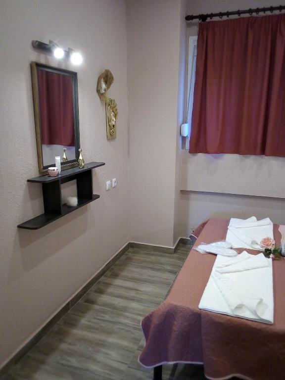 A bed or beds in a room at Athanasia inn II