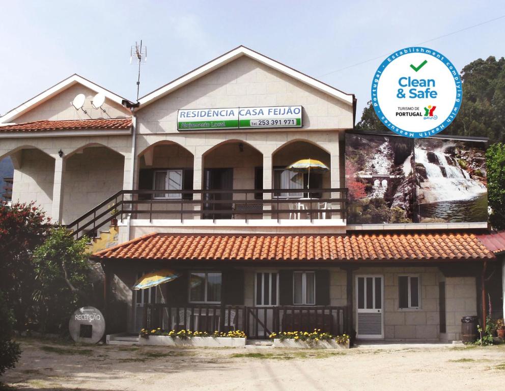 a building with a sign on the side of it at Casa Feijao - Alojamento Local in Geres