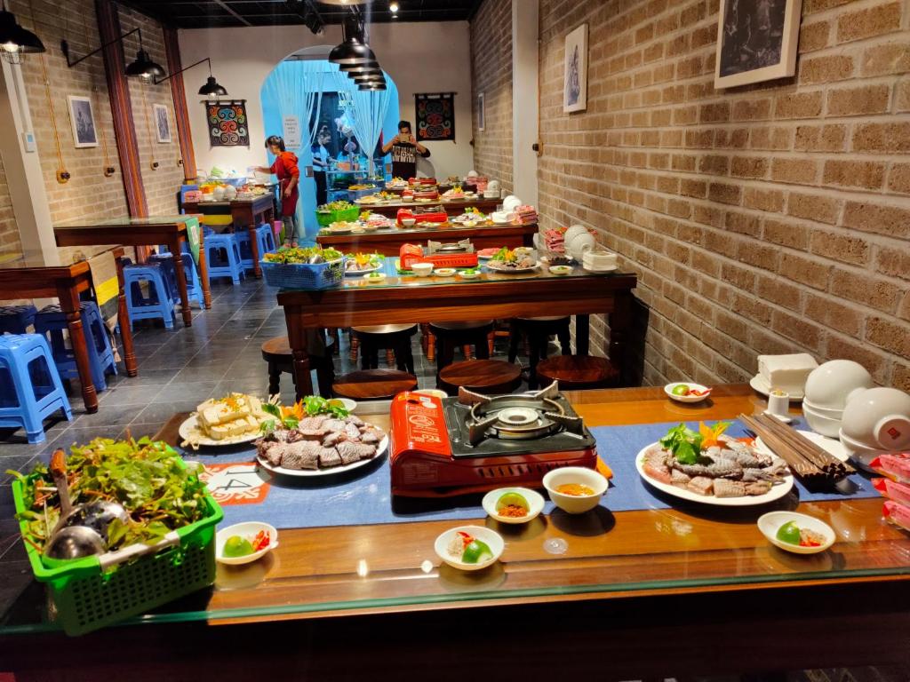 a buffet with many plates of food on a table at Ethnic House Lounge bar & hostel in Dồng Văn