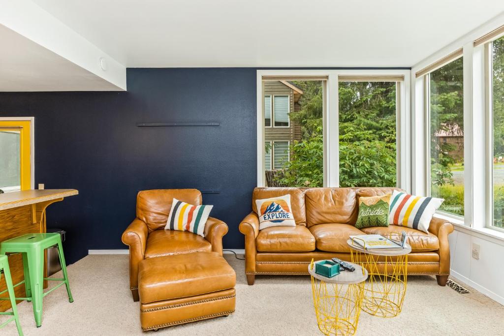 a living room with a leather couch and chairs at Shimmy Shack at 101-A Snowbird in Girdwood