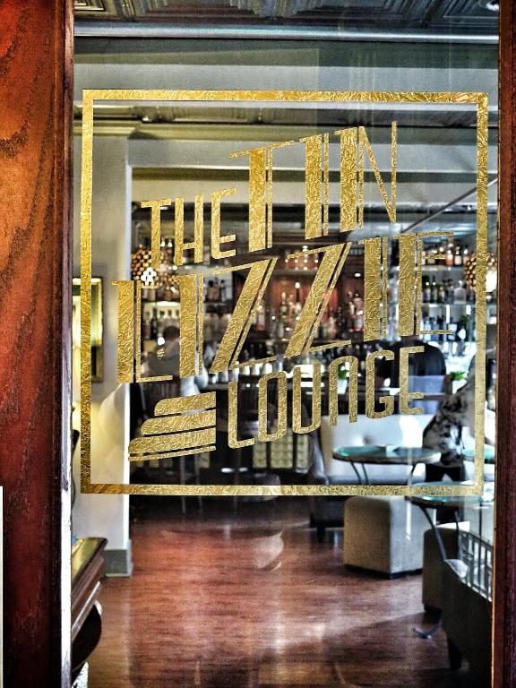 a store window with a sign that reads the hotel lobby at MarQueen Hotel in Seattle