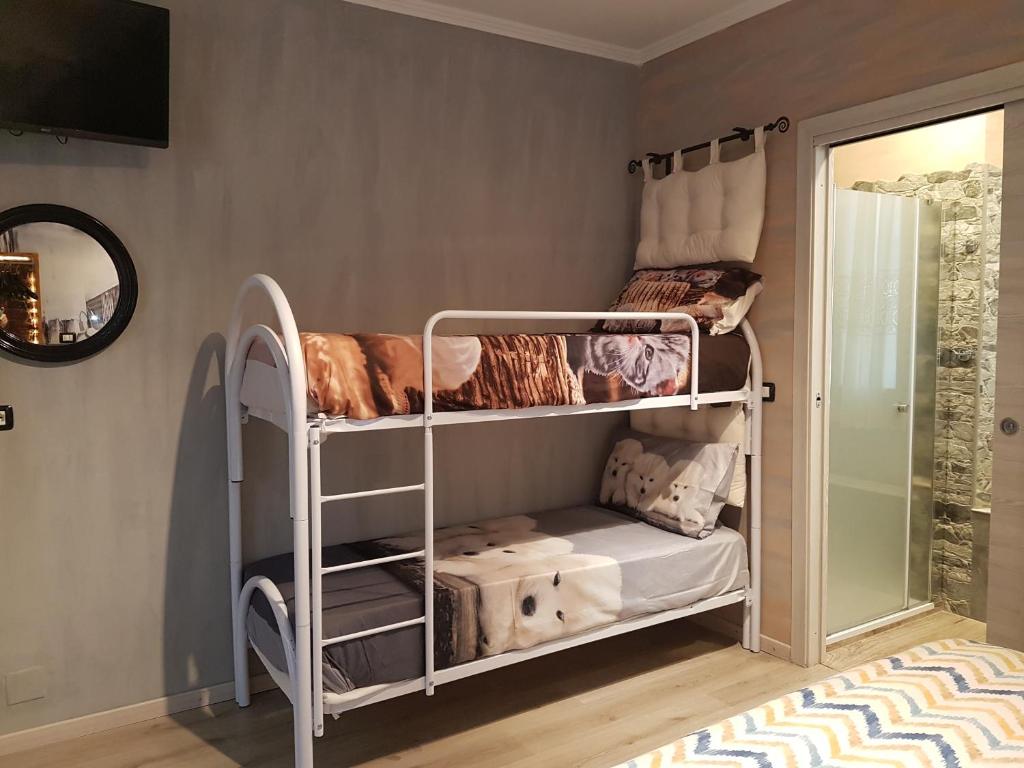 アッピアーノ・ジェンティーレにあるB&B Le Palmeの二段ベッド2台と鏡が備わる客室です。