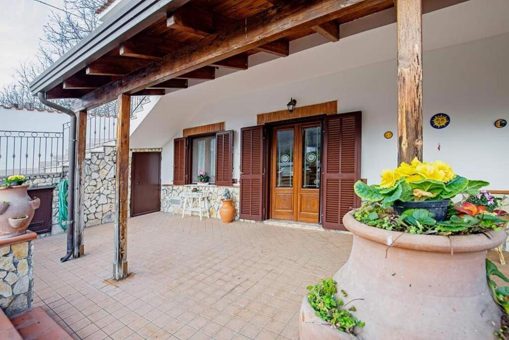 a porch of a house with a vase of flowers at countryhomeantonella in Castel San Giorgio