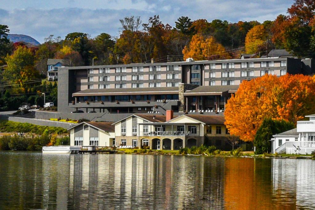 a large building next to a body of water at The Terrace Hotel at Lake Junaluska in Lake Junaluska