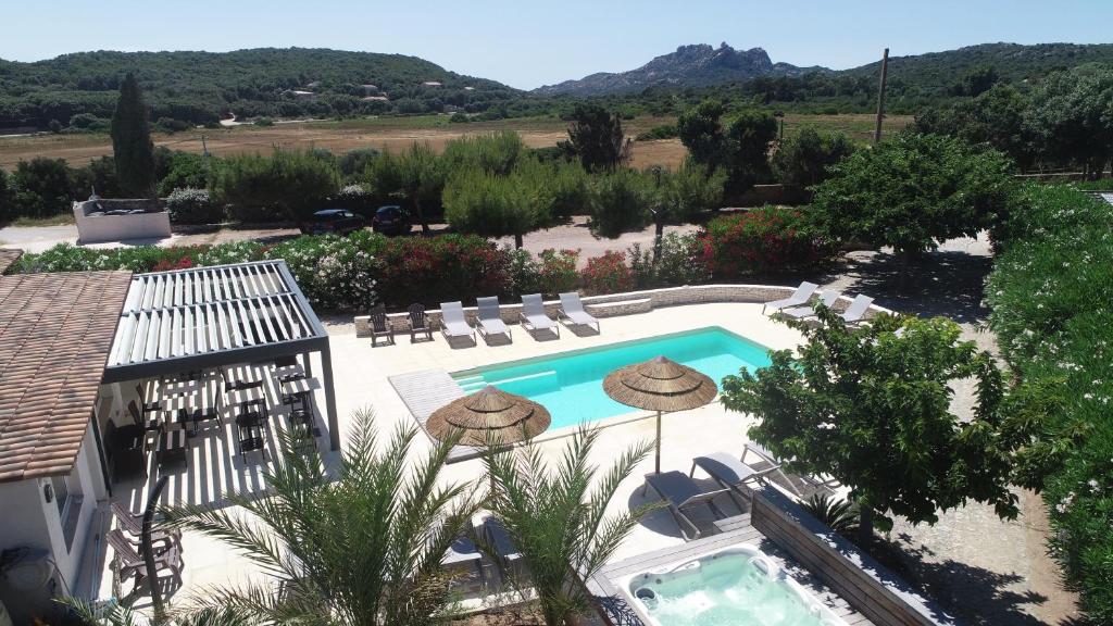 an image of a swimming pool with chairs at Hôtel Padolo in Bonifacio