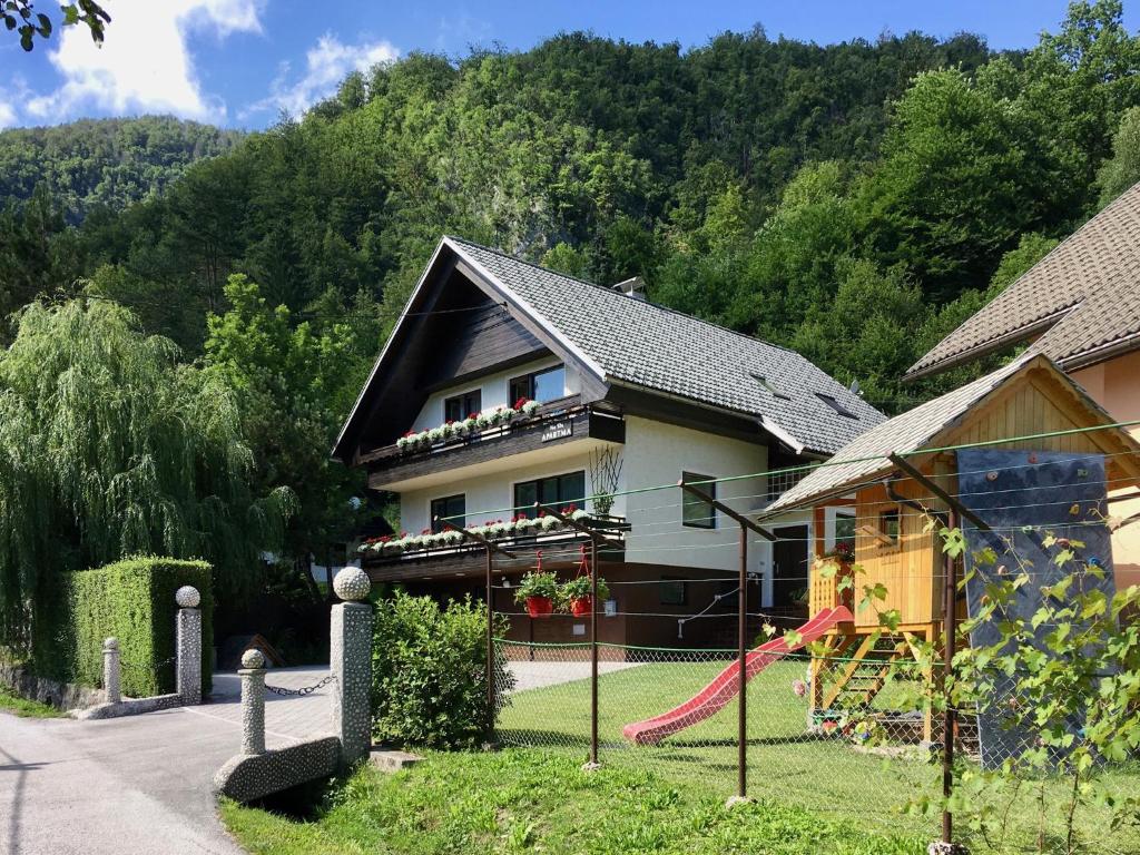 a house with a red kite in front of it at Apartment Milena in Nomenj