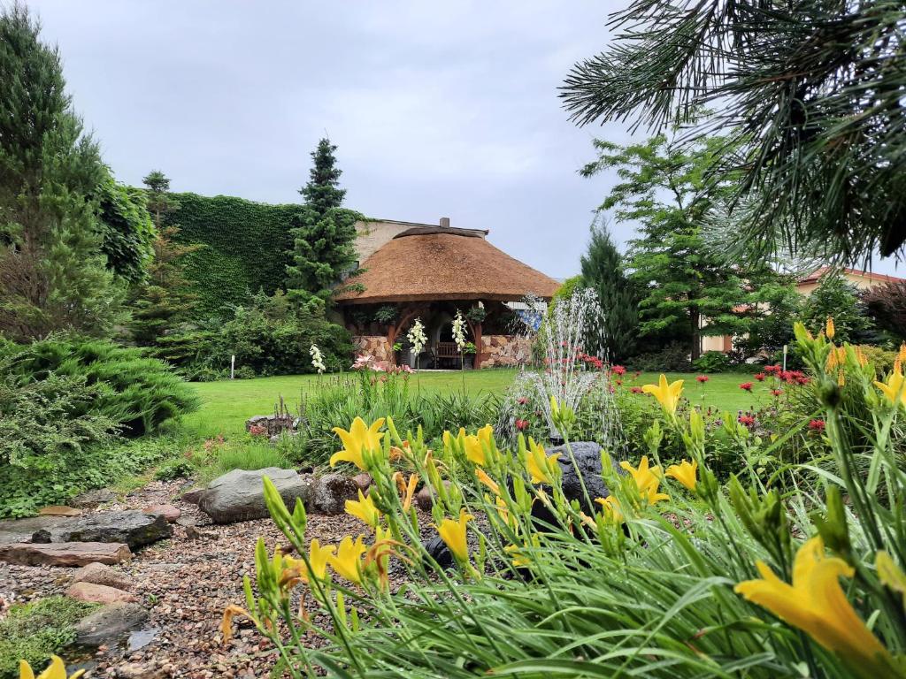 a garden with a gazebo in the background at Agro Relax Nowodwór 2 in Nowodwór