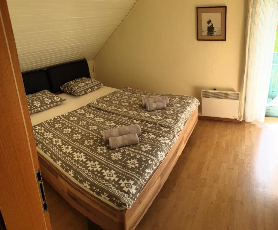 a bedroom with a bed with two pillows on it at Apartma Bellevue Rogla in Vitanje