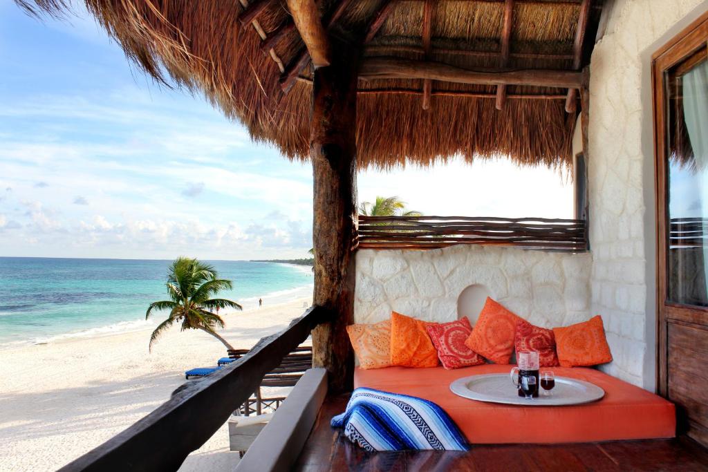 a room with a table and a view of the beach at Chica in Tulum