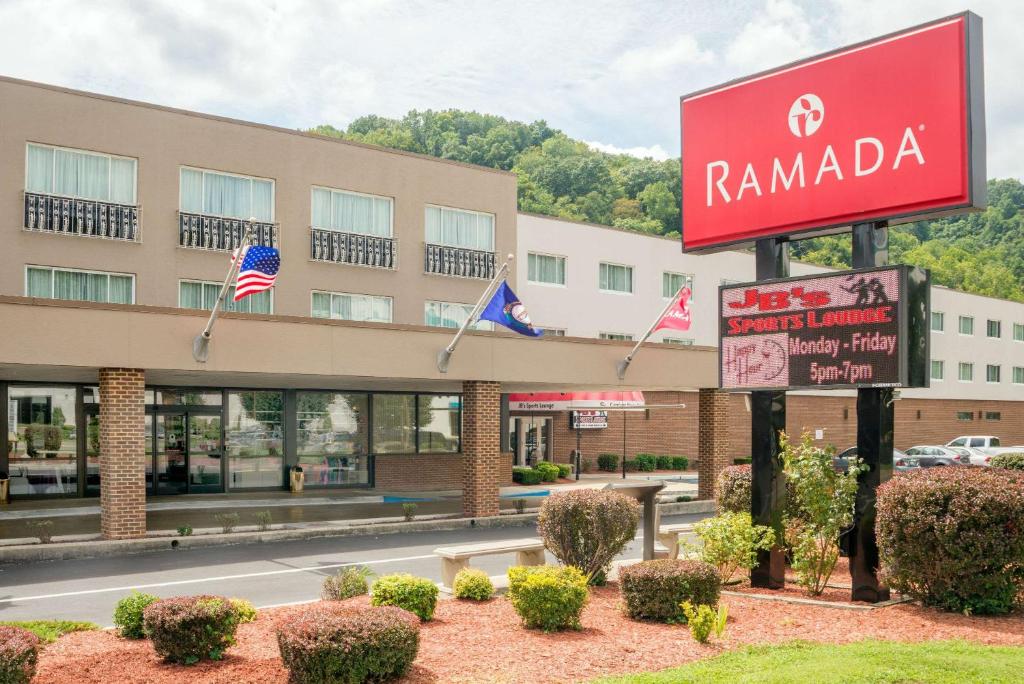 a hotel with a sign in front of a building at Ramada by Wyndham Paintsville Hotel & Conference Center in Paintsville