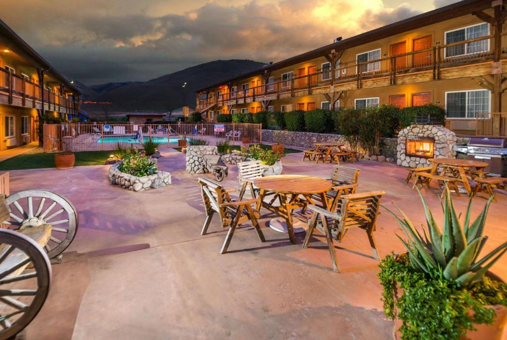 a patio with tables and chairs in a courtyard at Days Inn by Wyndham Lebec in Grapevine