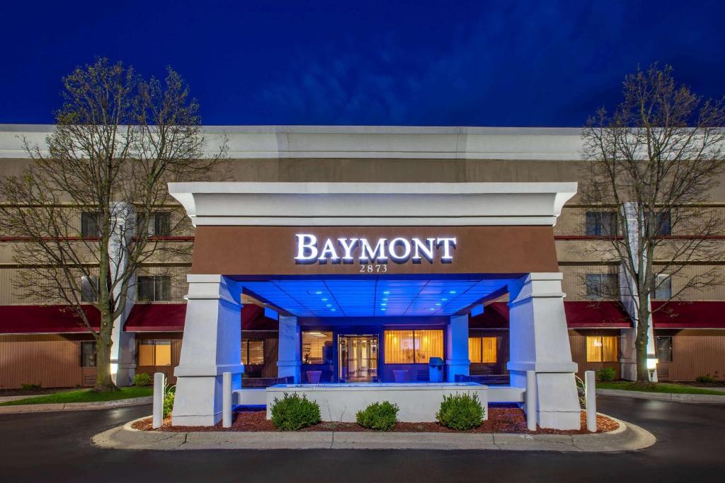 Baymont by Wyndham Grand Rapids Airport في غراند رابيدز: مبنى الفندق مع علامة تنص على داونويت